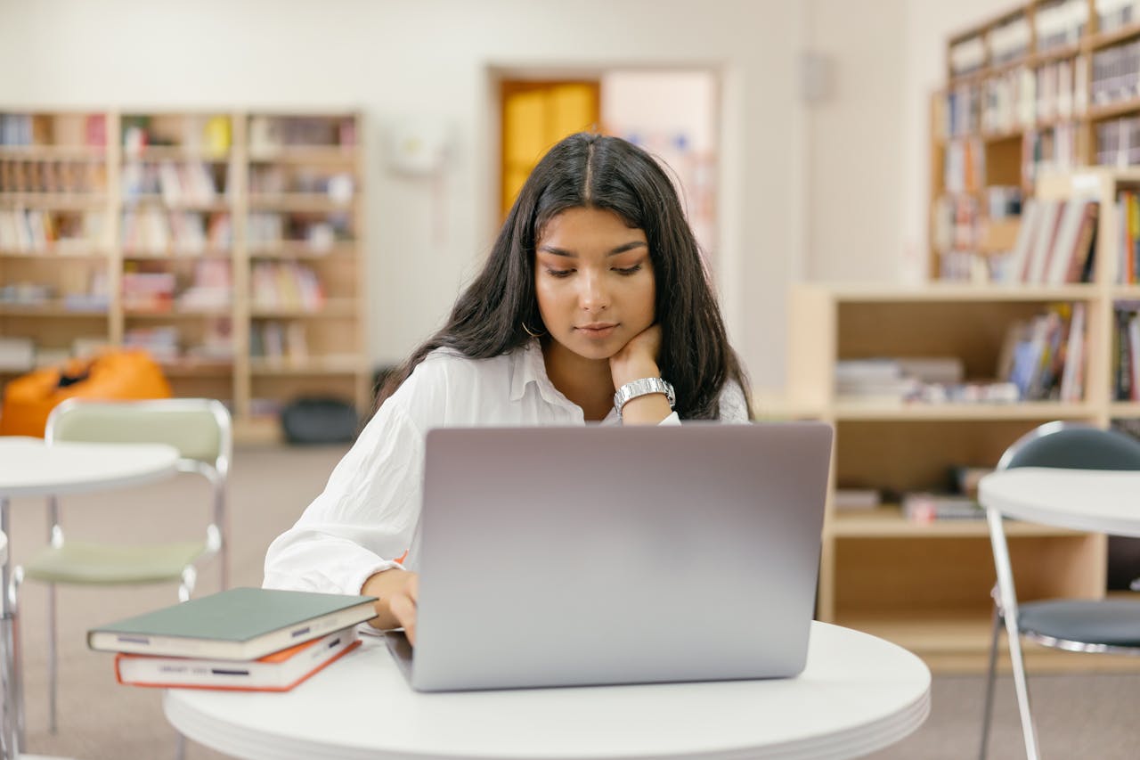 a female student exploring different essay formats on laptop