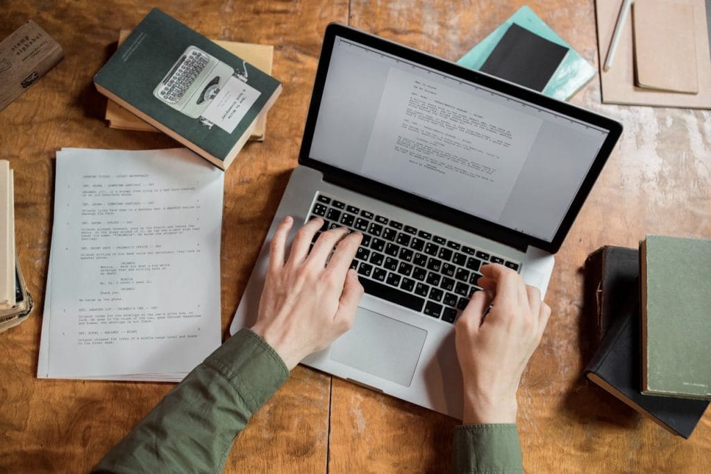 student writing essay on laptop